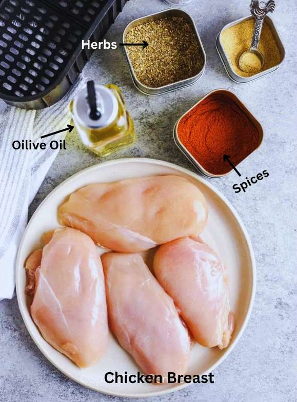 Chicken breast with oilive oil, spices and herbs ready to marinate